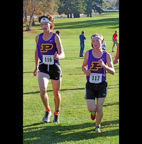 Matt Sitter, left, and Quin Stewart compete Saturday in Polson. Stewart crossed the finish at 17:20:24, the fastest time for the Polson boys’ team.