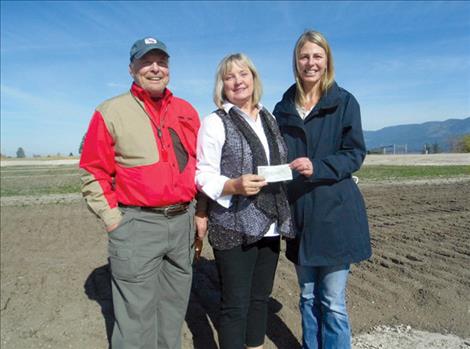Mike and Janna Taylor are pictured with PYSA board member Sarah Beck Smith at the new Polson Youth Soccer Complex.