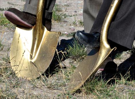 Golden shovels dug into the ground where the new clinic is being built.