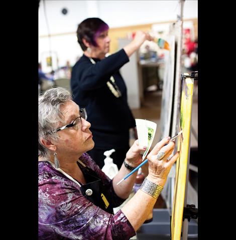 Juanita Small Salmon and Olivia Olsen create art during the fundraiser.