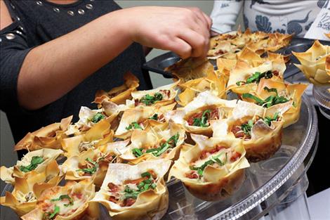 Volunteers serve dinner  during the auction.