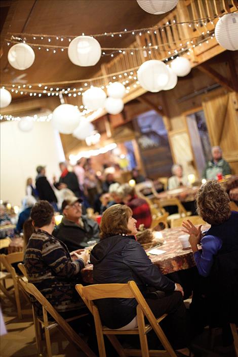 People visit inside the warm McCrumb Barn venue as they support The Nest during Sunday’s fundraiser.