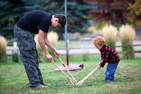 William Phillips plays stickball with Treydon Tryon.