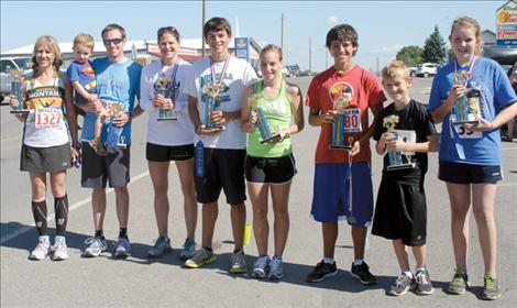 Buffalo Run winners are: (left to right) Susan Matter (female half-marathon overall winner); Bryant Jacobs (male half-marathon overall winner); Amy Pavlock (female 7-mile overall winner); Tyler Courville (male 7-mile overall winner); Nicole Brist (female 4-mile overall winner); Paden Alexander (male 4-mile overall winner); Eli Williams (male 1-mile overall winner); and Leila Marsh (female 1-mile overall winner).