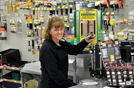 Beverley Osterwyk, store owner, checks the inventory on the shelves. 