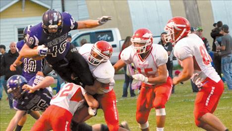 Arlee Warriors tackle Charlo’s Jade Smith when the two rivals faced each other earlier in the season. Both teams move on in state playoffs.