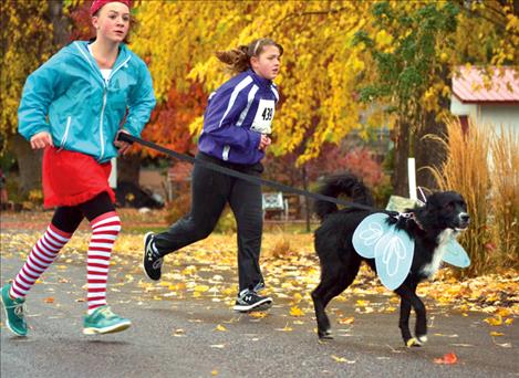 Participants — including several dogs — braved drizzly weather to run in a 1-mile fun run and a longer 5K while dressed in costumes.