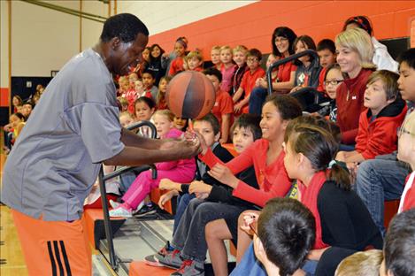 Joe “the trick-star” Odhiambo not only teaches students, including Kadynce Couture, to spin a basketball, but demonstrates five attributes of success during assemblies held Friday in Ronan.