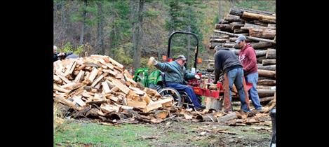 Pruitt Helm splits a pile of firewood at his home.