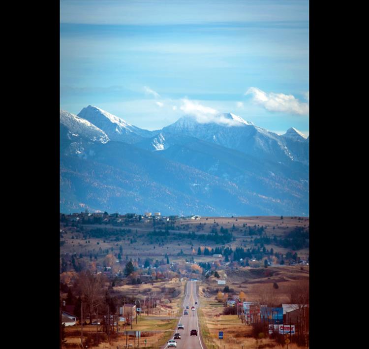 Drivers are treated to a fantastic view of the snow-capped mountains under a blue sky as they travel south on Jette Hill along Highway 93 north of Polson.