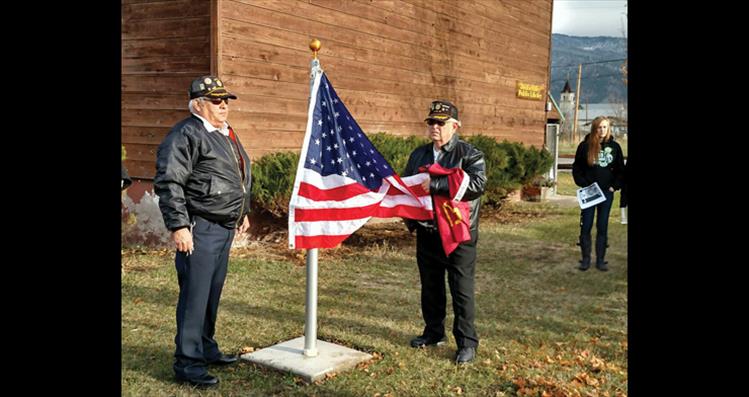 A new flagpole was installed during a flag honoring ceremony on Veterans Day at the Arlee Community Brown Building, where new American and Confederated Salish and Kootenai Tribes flags were raised. The American Legion Post 113 in Arlee hosted the event.