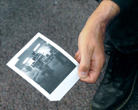 David Spear shows students a photo taken with a pinhole camera by one of the eighth-grade students.