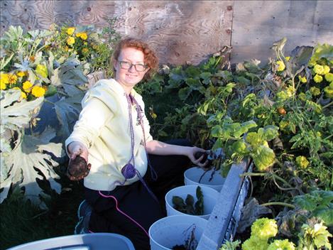 Elizabeth Bjorge harvests food from the school garden.