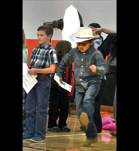 Stanley Pablo dances as he waits to have his school photo taken.