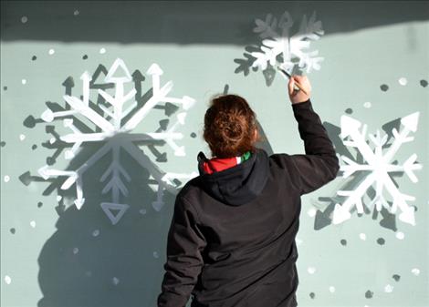 Carsten Rhine creates snowflakes in downtown Ronan.
