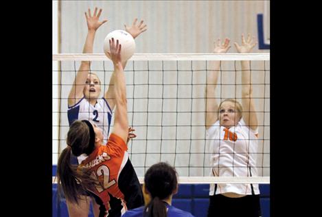 Mission’s Loren Erickson and Ronan Maiden Larissa Witters try to stop a hit from Ronan’s Alaina Madsen during the Mission Valley all-star volleyball game.