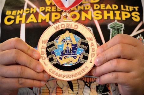 Rachelle Meidinger holds her competiton medal from the World Association of Benchers and Deadlifters.