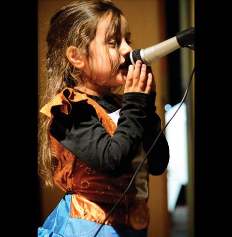 Elora Etches, 4, sings on stage.