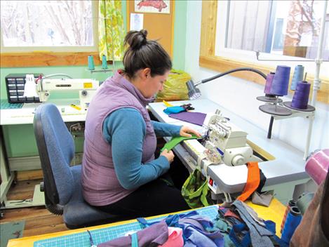 Carol Lynn Lapotka of Recreate Designs sews at her workshop in St. Ignatius.