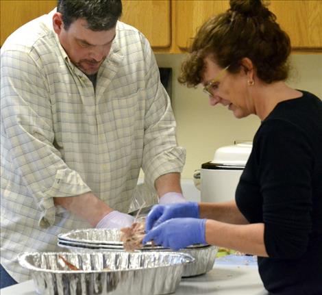 C.J. and Lisa Brucker help prepare turkey at Mission Middle School.