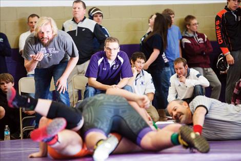 Coaches offer instruction and encouragement off the mats.