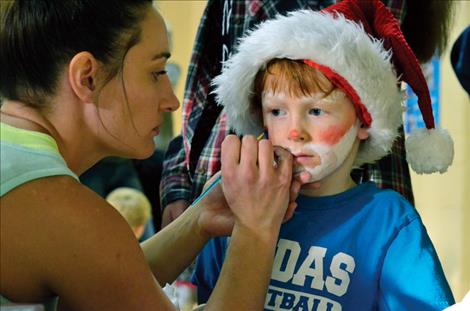 Aodhan Umphrey, 6, gets his face painted. 