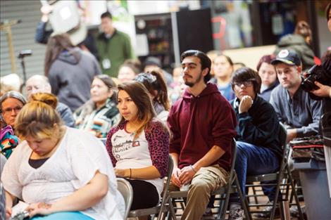 Community members and students listen to the candidates respond to questions. 