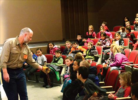 Byron Crow shows students a tiny owl named Frank.