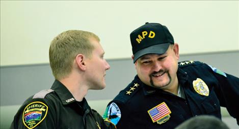 School Resource Officer Clay Shoemaker and St. Ignatius Police Chief Matthew Connelly visit during a community breakfast at the Mission school. 