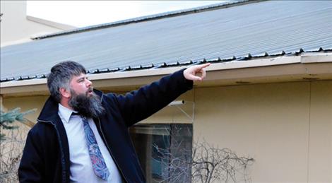 Superintendent Jason Sargent shows the school's roof problems to a group of concerned community members.
