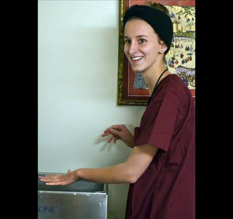 Hailey Schippers prepares to stick her hand in warm wax in the physical therapy departmen