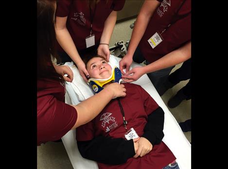 Ronan student Louetta Conko-Camel acts as a patient while touring the emergency room at St. Luke Community Hospital.