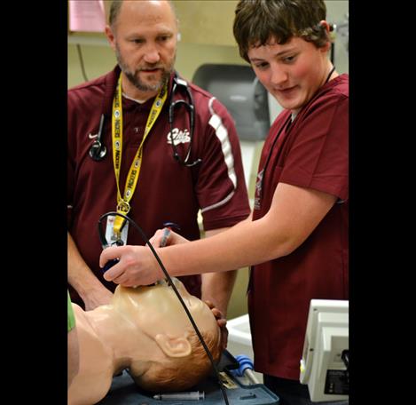 Ronan student Corbin Davis practices intubating a dummy while visiting the emergency room. 