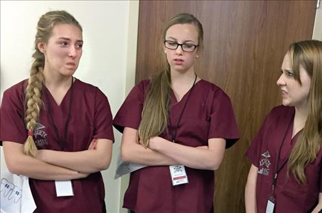 Students react to a photo of an open wound while touring the physical therapy department.