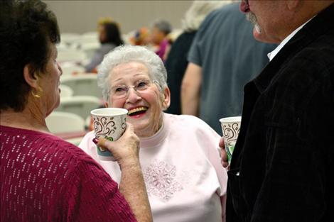 Marie Cowen shares a laugh with friends who gathered Thursday at the Ronan Community Center. Cowen started the free holiday dinner in 1997.