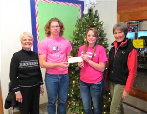 Pictured from left are Charlo football player Dugan Runkle, Barbara Morin representing Cheerful Heart, Inc.,  Charlo volleyball player Sakoya Gaustad and Valerie Lindstrom. 