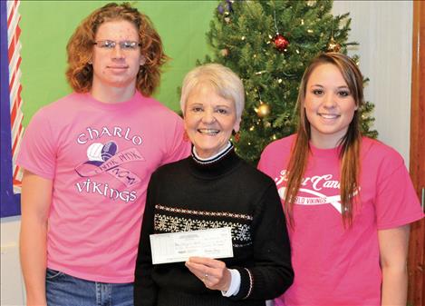 Pictured from left are Charlo football player Dugan Runkle, Barbara Morin representing Cheerful Heart, Inc., and Charlo volleyball player Sakoya Gaustad. 