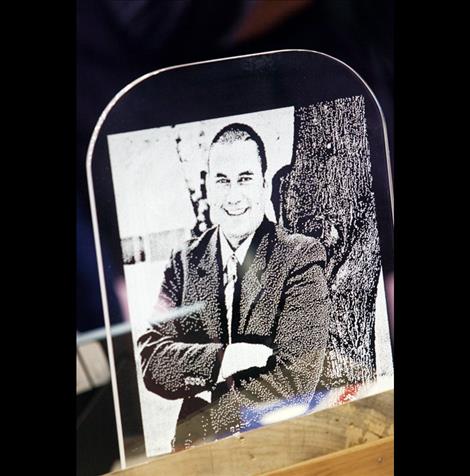 An etching of Robert DePoe III, the third president of Salish Kootenai College, was on display at his funeral service Monday in the Joe McDonald Fitness Center Gym.