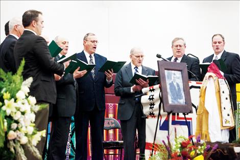 A men's choir sings at the service.