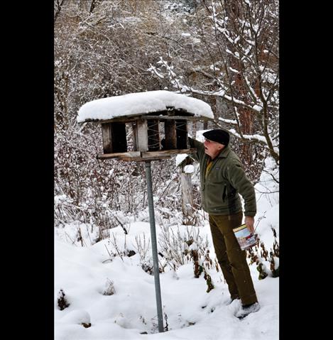 Jerry McGahan feeds the birds outside his home.