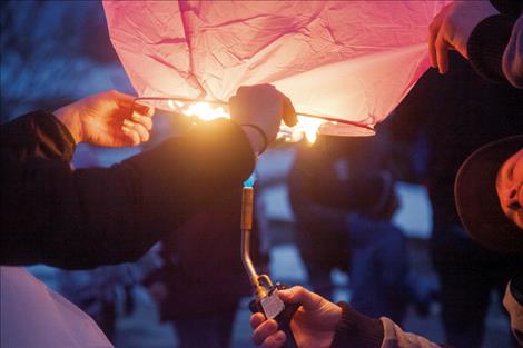 A torch is used to light the lanterns.
