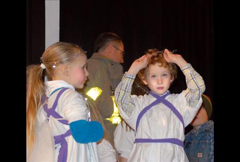 Kaycee Wright, left, watches as Logan Smith adjusts his halo before dress rehearsal of “The Best Christmas Pageant Ever.”