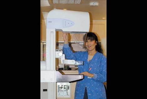 Coach technician Margie White adjusts the mammography machine inside the coach.