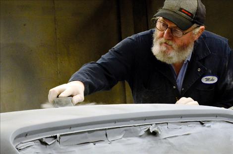 The primer on the 1972 Chevy El Camino Super Sport is sanded smooth before it can be painted inferno orange