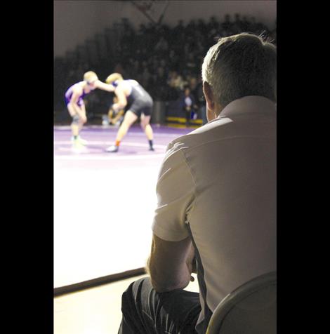 Coach Bob Owen concentrates on a wrestling match.