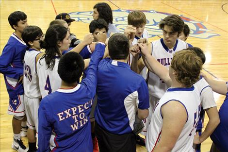 The Mission Bulldogs huddle before Friday’s home game against Ronan.