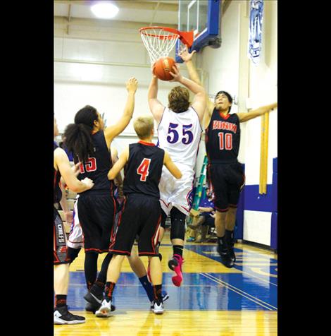 Mission’s Tyler Spidel pushes to the hoop during Friday’s home game against Ronan.