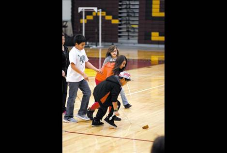 Children dive for the ball with glee during a double-ball match on Saturday