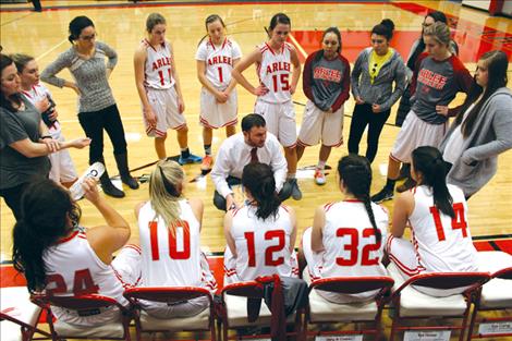 Arlee Scarlets Head Coach Bill Stockton talks to his team, a group of players with size and experience working for them.  