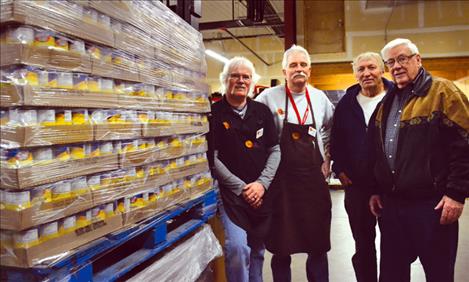 Harvest Food employees Kyle Salmonson and J.D Matthews prepare pallets of soup for Ronan Seventh Day Adventist church members Del Desjarlais and Russ Jenkins.